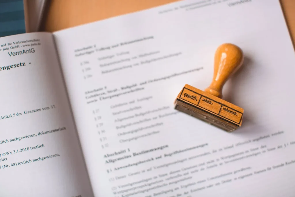 China trademark registration: A wooden rubber stamp resting on an open German legal document