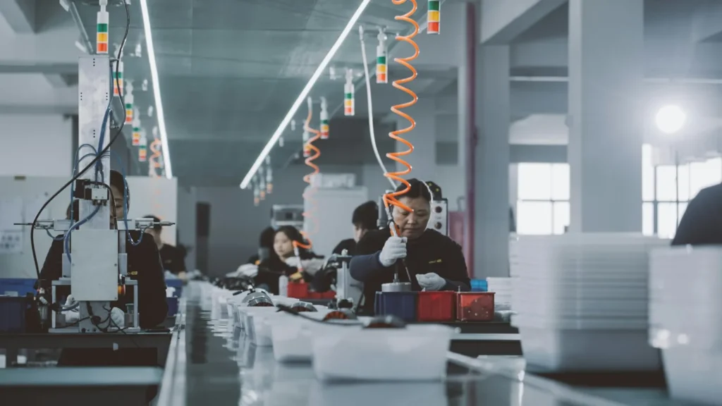 Chinese New Year 2027 factory shutdown: a group of people working in a factory