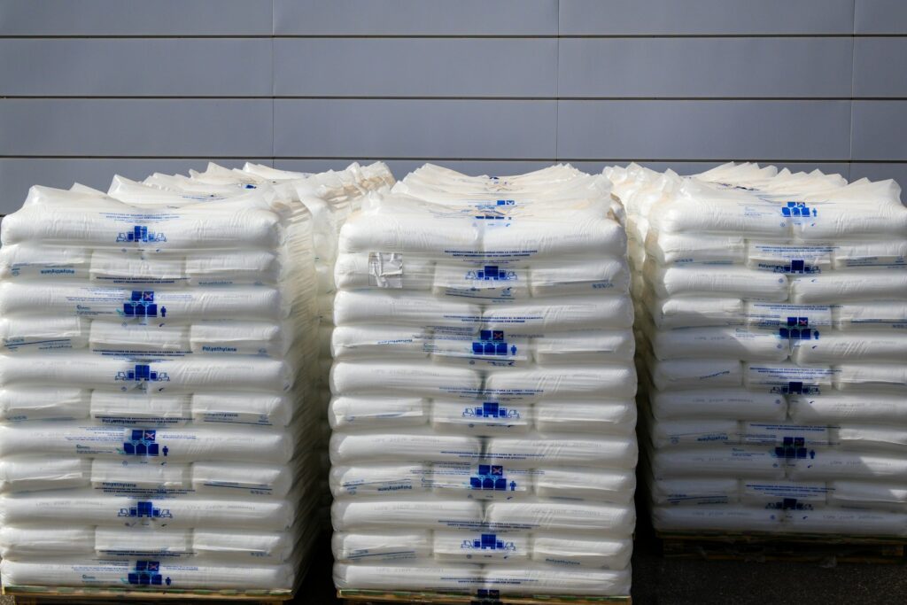country of origin verification: stacked industrial sacks on pallets in a warehouse